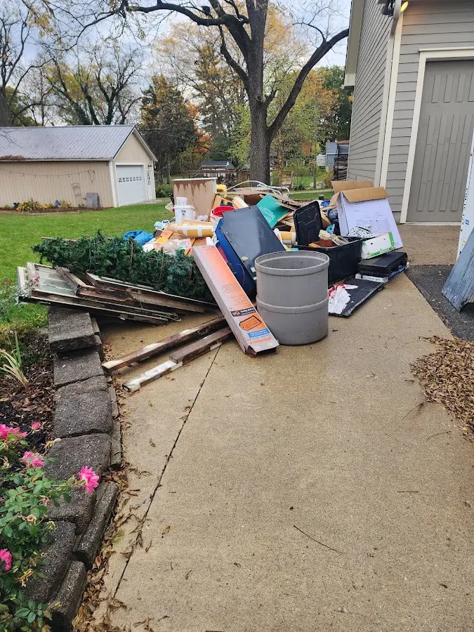 Dumpster being loaded with debris for 12 Yard Dumpster Rental in Vail
